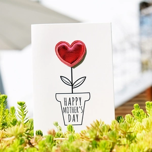 DIY Mother's Day card with a 3D red leather heart and flower pot in natural light
