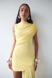 Detail of yellow bodycon dress showing elegant pleated texture and ruching design