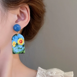 Artistic oil painting sunflower drop earrings with klein blue studs worn on ear