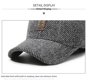 Detailed macro view of gray tweed baseball cap with extended brim and leather EDIKO logo