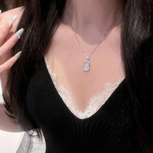 Elegant stainless steel gourd necklace with zircon inlays worn on a woman's collarbone