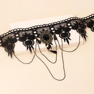 Detail of gothic black lace choker with vintage bronze base and dark gemstone pendant