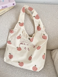 Canvas tote bag with pink peach prints and sweet taste of peaches text on white fabric