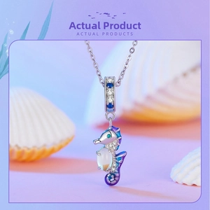 Macro view of S925 silver seahorse charm with purple enamel and white moonstone