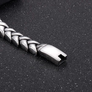 Detailed macro view of 11mm silver wheat link chain bracelet with a square clasp