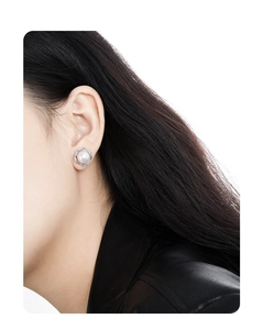 Close-up of S925 silver pearl stud earring with crystal flower border worn on ear