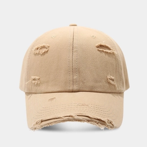 Close-up of distressed vintage baseball cap showing frayed details and torn cotton fabric