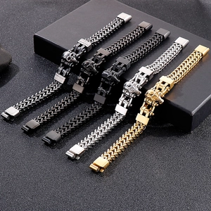 Collection of men's punk skull bracelets in gold, silver, and black on textured display