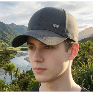 Close-up of a men's dark grey baseball cap featuring a metal logo and fine stitching details