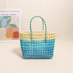 Colorful woven beach tote bag in yellow and blue bicolor design for seaside vacations