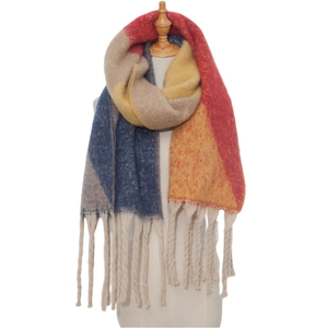 Close-up of thick tassels and colorful jacquard knit fabric on a winter shawl