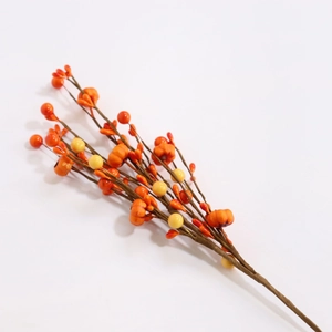 Autumn artificial branch with orange pumpkins and berries for Thanksgiving decoration