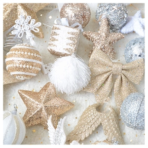 Detailed flat lay of golden and white Christmas ornaments with glitter and plush texture