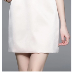 Close-up of white dress hem featuring premium lace splicing and heavy beadwork detail