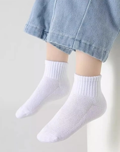Detail of white mesh breathable cotton socks for kids with comfortable elastic cuffs