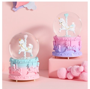 Detail of magical unicorn crystal ball music boxes with pastel gradient carousel bases