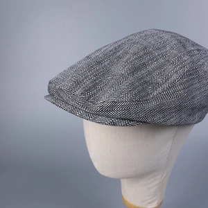 Detail shot of the black and white herringbone pattern weave on this stylish flat cap