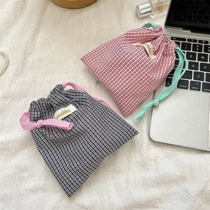 Detail of red and black checkered cotton drawstring bags for cosmetics storage