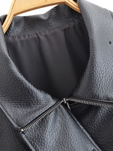Détail d'une veste en similicuir grainé noir avec col et fermeture éclair argentée