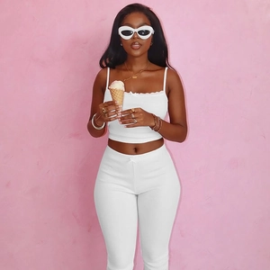 Detail of white ribbed knit summer two-piece set with lace camisole and slim-fit trousers