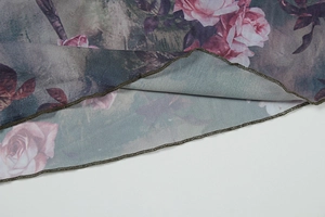 Detailed macro view of delicate pink rose floral print and ruffled lettuce hem edge