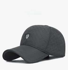 Detail of gray winter baseball cap showing diamond quilted stitching and R logo emblem