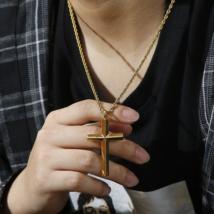 Polished gold cross pendant necklace for men with 3mm twisted rope chain on model