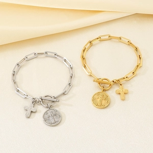 Detail of OT buckle double layer bracelet with cross and pearl pendant on silk background