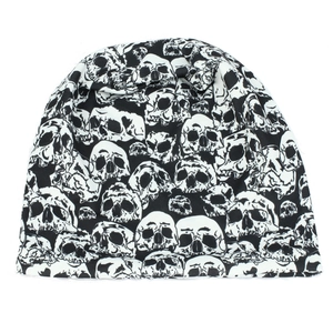Detail view of the soft knitted beanie featuring a graphic white skull all-over print