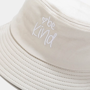 Beige cotton bucket hat featuring white be Kind heart embroidery and premium stitching