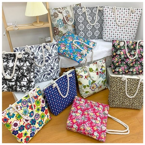 Detailed collection of assorted floral and geometric print canvas tote bags with rope handles