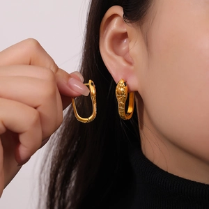 Golden snake hoop earrings with crystal eyes and geometric textures for women