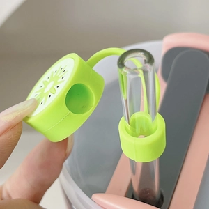 Detailed close-up of a green kiwi silicone straw cover protector and a clear glass straw