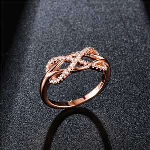 Macro shot of S925 sterling silver infinity ring with rose gold plating and pavé zircons