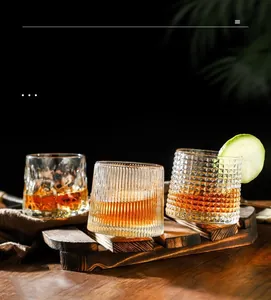 Detail of spinning whiskey glasses with embossed diamond and geometric textures