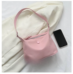 Pink minimalist nylon hobo bag size comparison with a smartphone showing capacity