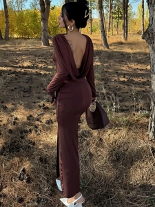 Detail of elegant open back design on a slim fit brown long sleeve slit dress