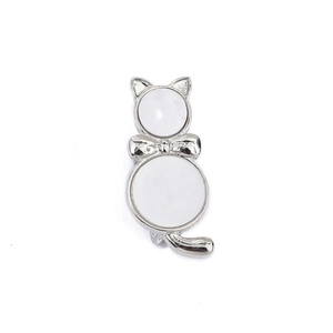 Detailed view of cat butterfly brooch pin with silver alloy and white inlay details