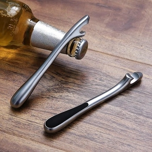 Close-up of a dual-set zinc alloy garlic press and bottle opener on a wooden table