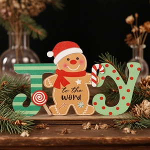 Detail of wooden gingerbread man JOY ornament with festive pine and dried flower decor