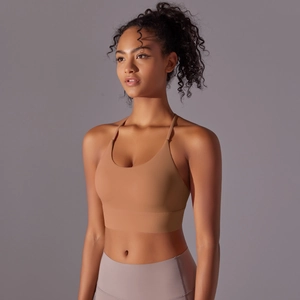 Detail of cross-back straps on seamless brushed nylon sports bra in earth tones