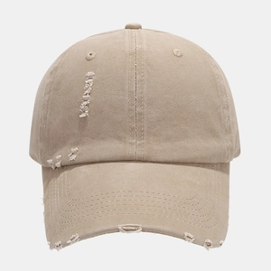 Distressed solid color baseball cap in khaki cotton with vintage torn brim style