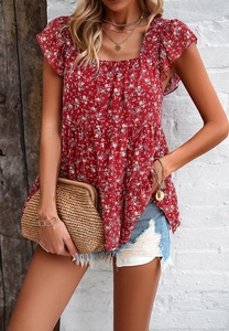 Detail of red floral print square neck top with flutter sleeves on a model
