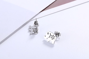 Detailed view of elephant stud earrings with hollow flower patterns and crystal eyes