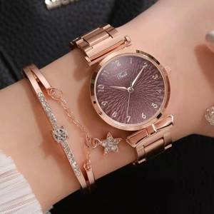 Close-up of rose gold watch and star bracelet set with purple sunray dial on wrist