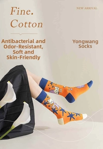 Detail of crew cotton socks with cat and moon patterns in orange and navy blue