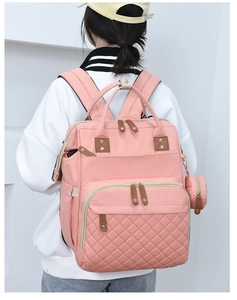 Pink quilted diaper backpack for moms with small round coin purse accessory