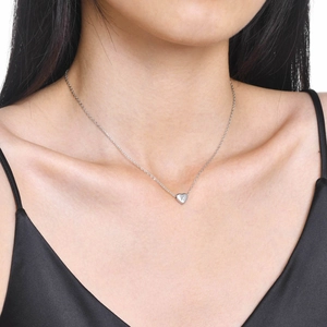 Close-up of heart pendant necklace with letter K engraving worn on collarbone