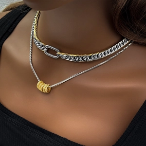 Detail of 9mm two-tone Cuban link necklace set with ring clasp and crystal charms