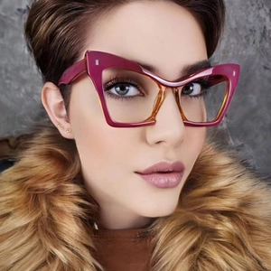 Close-up of oversized cat-eye glasses frame with purple and yellow gradient finish